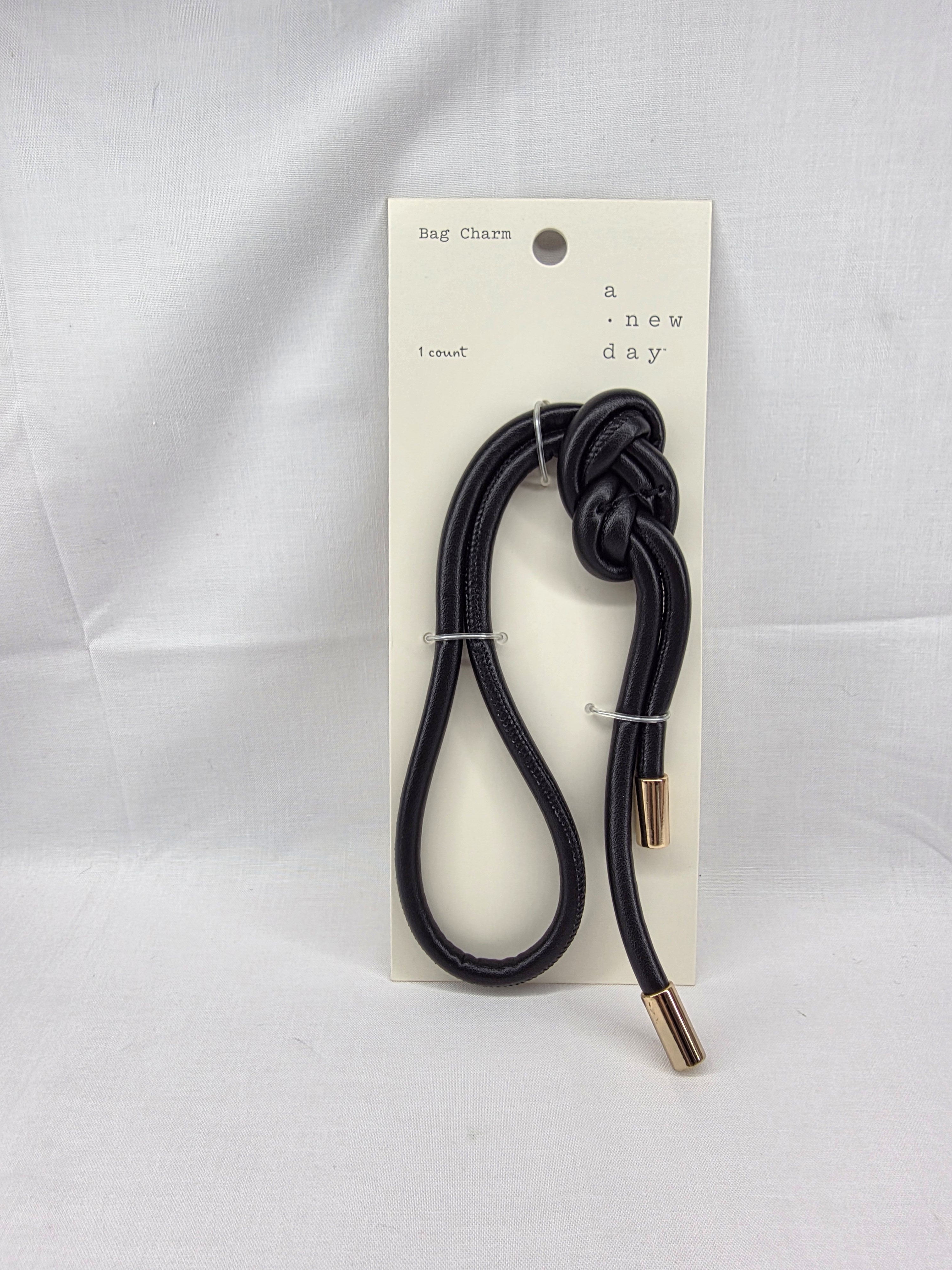 A New Day Black Knot Bag Charm With Gold-Tone Caps